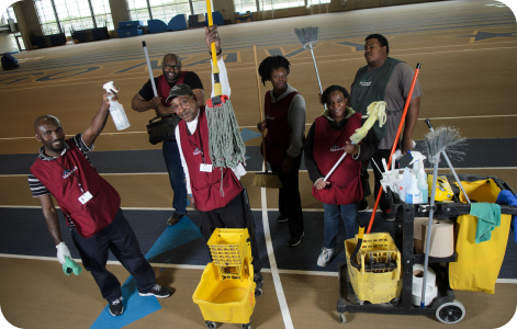 A colored photo taken in the 2010s, showing a group of cleaners smiling for the camera.