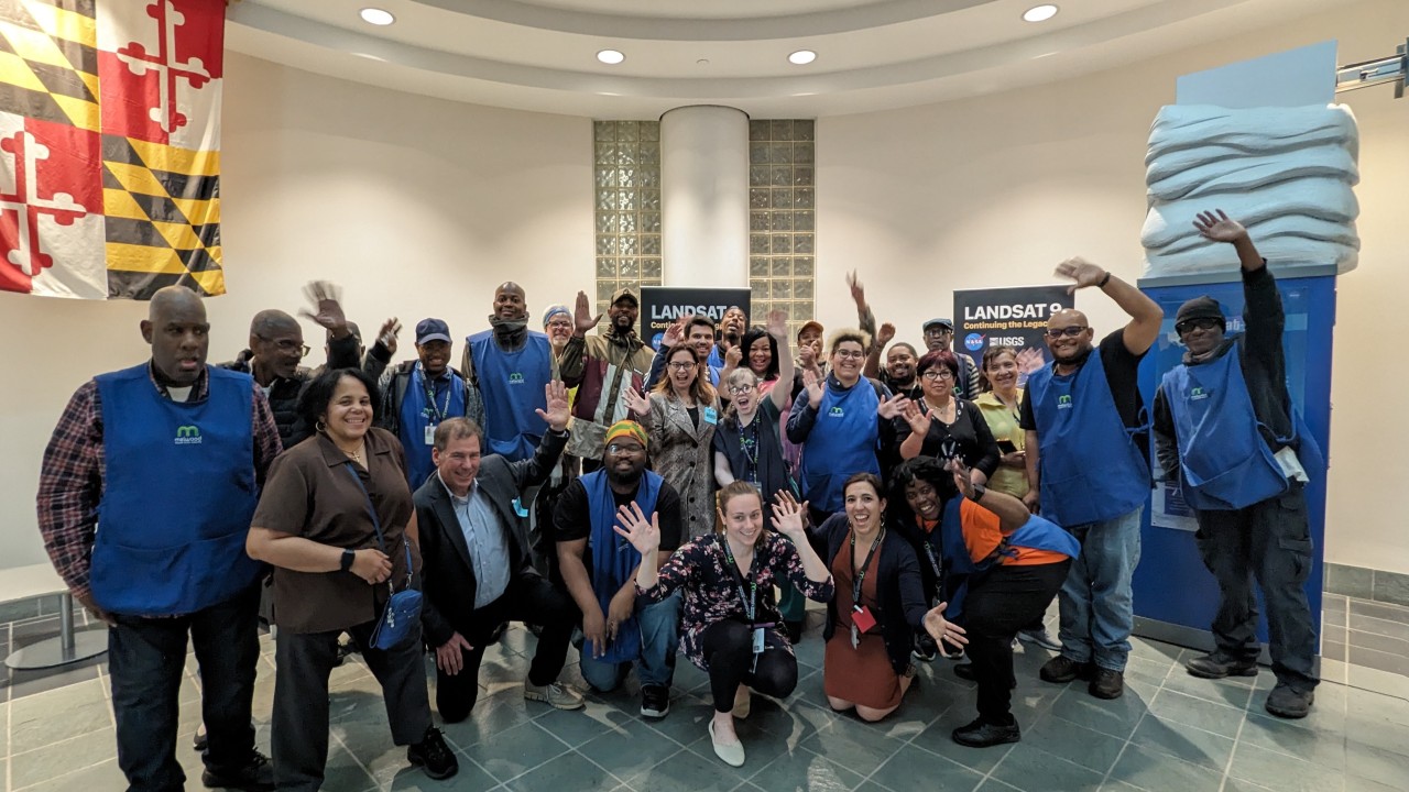 A photo of Melwood employees and leadership, including Larysa Kautz, smiling and waving at the camera.