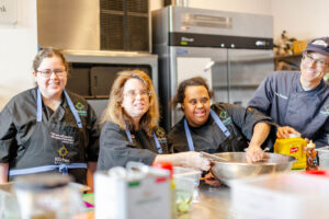 A group photo of the culinary course students and Dan Traster.