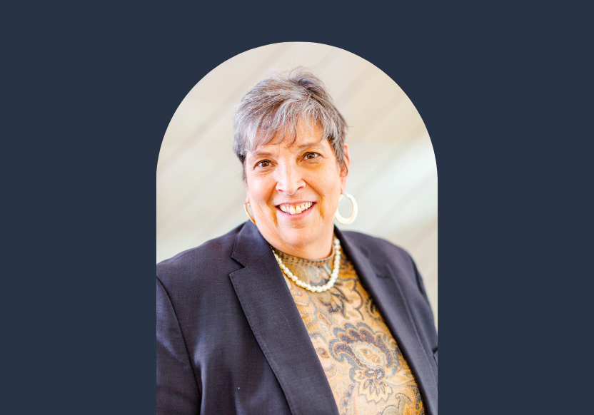Emily Homer, Executive Director of Melwood Community Services, smiling in front of blurred background, with arch shape around her photo