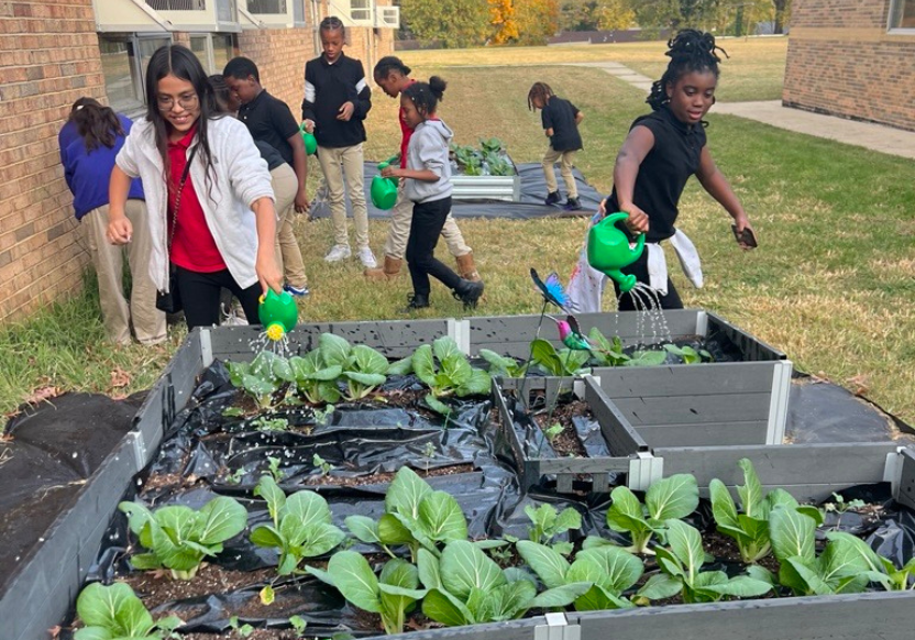 Kids watering plants at Apple Grove Elementary for Melwood Community Services' YES Program