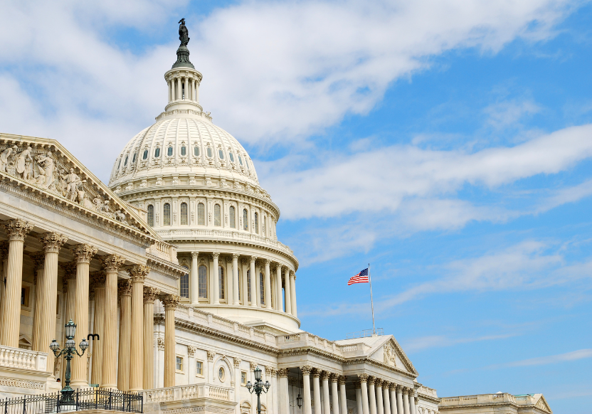 side view of U.S. Capitol building in front of a blue sky